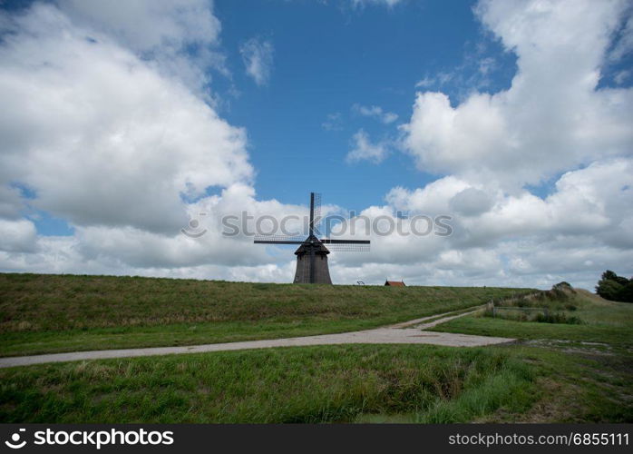 Dutch windmill with a cloudy sky in the summer