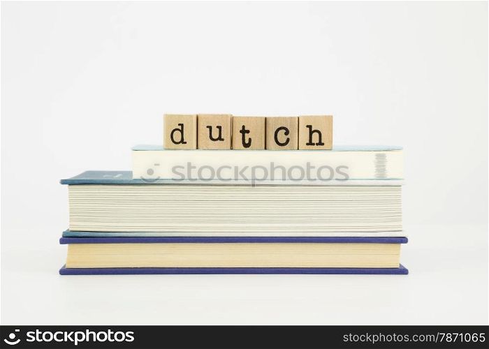 dutch word on wood stamps stack on books, language and study concept