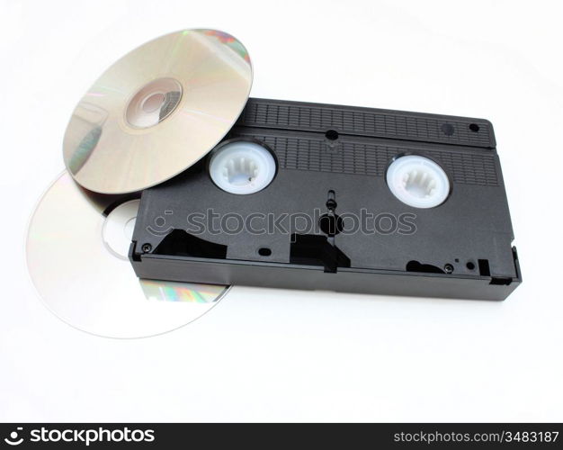 DVD disks and VHS video the cartridge on a white background in time and technology comparison