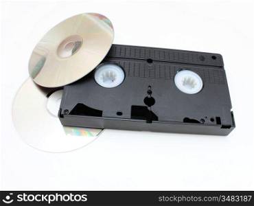 DVD disks and VHS video the cartridge on a white background in time and technology comparison