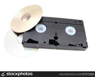 DVD disks and VHS video the cartridge on a white background in time and technology comparison