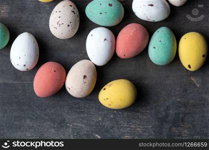 Dyed colorful easter eggs on a vintage wooden background texture, soft pastels modern design space for text. Dyed colorful easter eggs on a vintage wooden background texture, soft pastels modern design