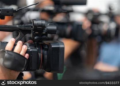 Dynamic media presence as TV cameras capture the energy of an outdoor press conference, delivering comprehensive coverage in an engaging setting. Media in Action  TV Cameras at Outdoor Press Conference