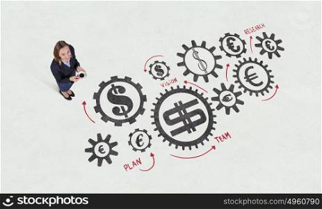 Dynamics of growth in business. Top view of businesswoman and graphs and diagrams on floor