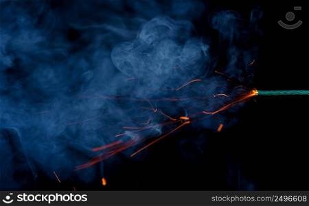 Dynamite fuse burn with fire smoke and sparkles on black background
