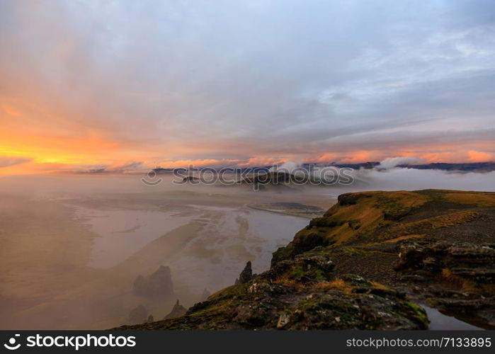 Dyrholaey rock formation at sunset. Dyrholaey is a promontory located on the south coast of Iceland, not far from the village Vik