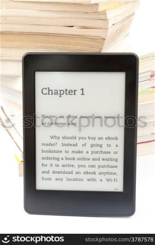 E-book reader leaning against pile of books