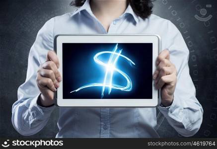 E-business and commerce concept. Woman financial assistant holding in her hands tablet with dollar sign on screen