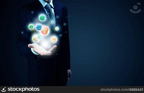 E-business and networking. Close up of businessman holding icons in his palm
