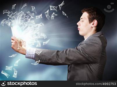 E-business concept. Young businessman looking seriously in tablet pc monitor