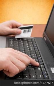 e-commerce concept. hands with credit card on computer keyboard