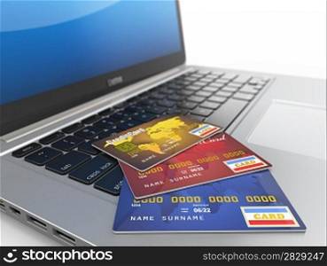E-commerce. Credit cards on laptop. Three-dimensional image.