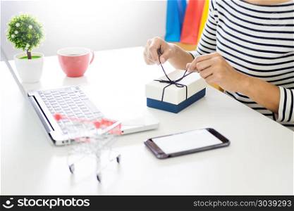 e-commerce delivery concept and online selling start up small business owner packing in the card box at workplace. freelance woman seller prepare product for packaging process at shop. . e-commerce delivery concept and online selling start up small bu