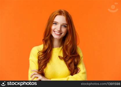 E-commerce, professionalism and employement concept. Cheerful pleasant redhead curly-haired woman in yellow sweater, standing confident with crossed arms and smiling camera.. E-commerce, professionalism and employement concept. Cheerful pleasant redhead curly-haired woman in yellow sweater, standing confident with crossed arms and smiling camera