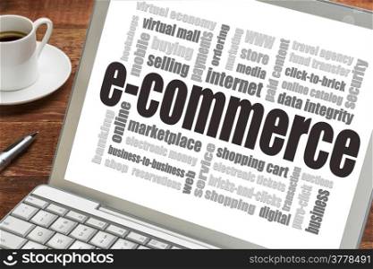 e-commerce word cloud on a laptop screen with a cup of coffee - internet business concept