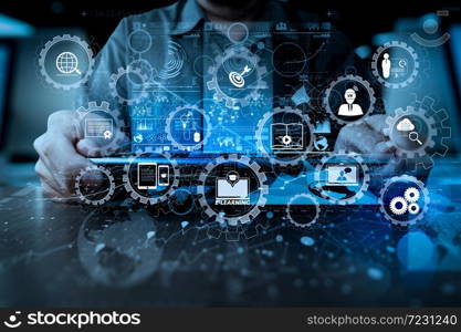 E-learning with connected gear cogs connected diagram virtual dashboard.businessman hand working with modern technology digital tablet computer and digital layer effect as business strategy concept