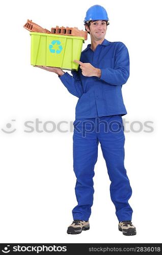 Eager tradesman pointing to a recycling bin