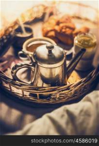 Early breakfast in bed: vintage coffee pot, Cup of coffee and croissants, close up, selective focus