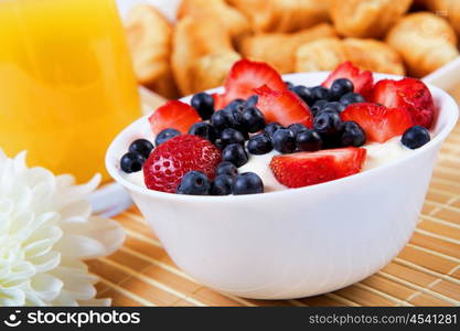 Early breakfast. Strawberries, cream and juice. The symbol of healthy lifestyles.