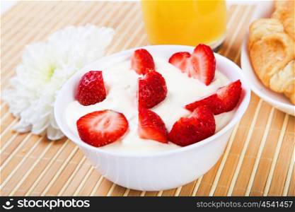 Early breakfast. Strawberries, cream and juice. The symbol of healthy lifestyles.