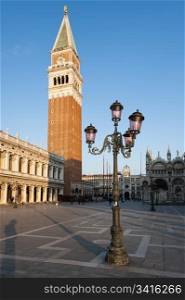 Early morning at the Piazza San Marco (St Mark&rsquo;s Square). Early morning at the Piazza San Marco (St Mark&rsquo;s Square). Campanile San Marco, Biblioteca Nazionale Marciana and famous Venetian street-lamp.