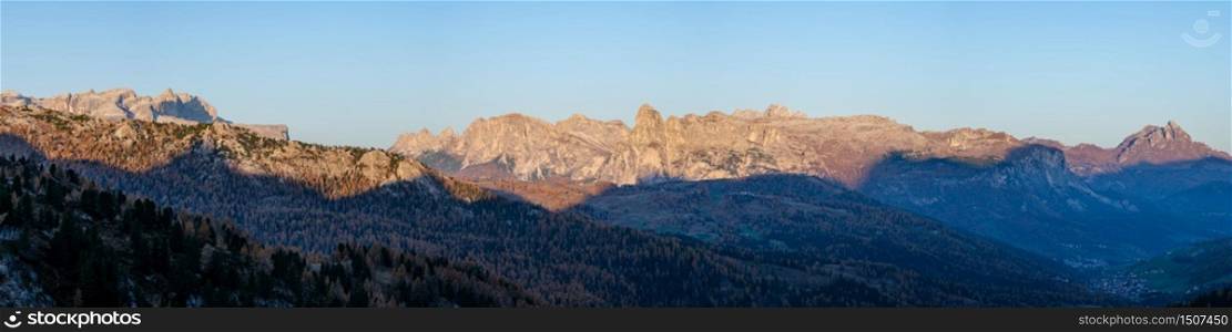 Early morning autumn alpine Dolomites mountain scene. Peaceful panoramic view from Valparola Pass, Belluno, Italy. Picturesque traveling, seasonal, and nature beauty concept scene.