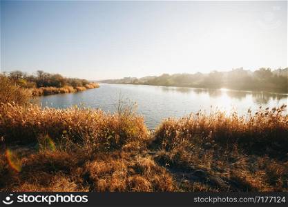 Early morning. Beautiful, colorful autumn lake in sunlight rays. Autumn background.. Early morning. Beautiful, colorful autumn lake in sunlight rays. Autumn background