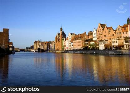 Early morning by the Motlawa river with scenic view on the Old Town of Gdansk in Poland