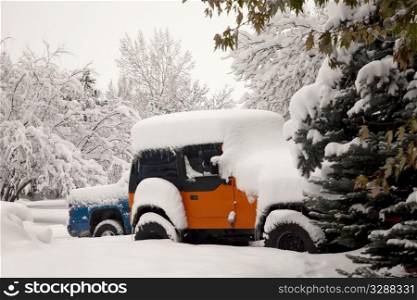 early morning driveway scene in Fort Collins, Colorado - cars after heavy November snow storm