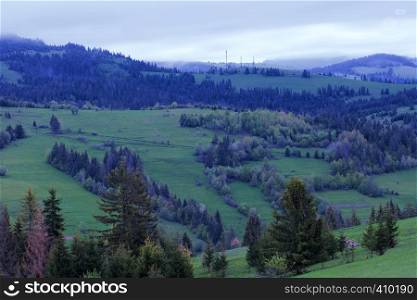 Early morning in the mountains of the Carpathians. Mountain landscape. View from the mountainside.. A cool blue morning in the Carpathian mountains.