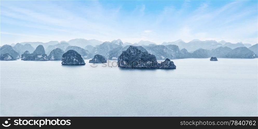 Early morning landscape with blue fog and limestone rocks at Ha Long Bay, South China Sea, Vietnam, Southeast Asia. Travel background, two images panorama