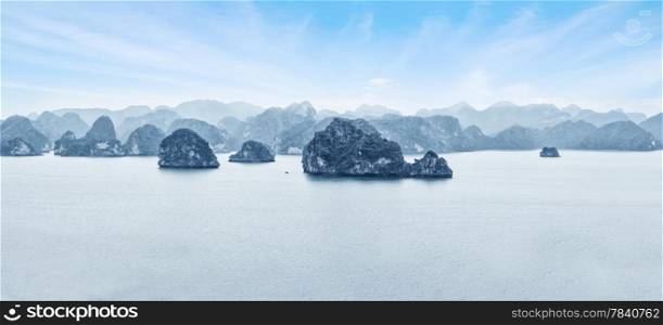 Early morning landscape with blue fog and limestone rocks at Ha Long Bay, South China Sea, Vietnam, Southeast Asia. Travel background, two images panorama
