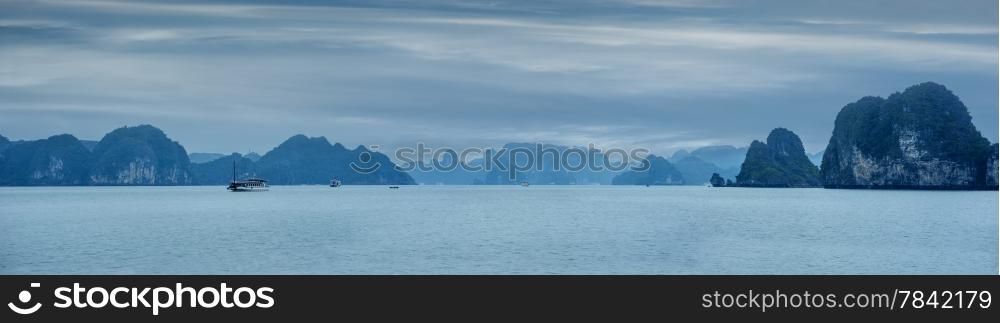 Early morning landscape with blue fog and tourist junks floating among limestone rocks at Ha Long Bay, South China Sea, Vietnam, Southeast Asia. Travel background, four images panorama
