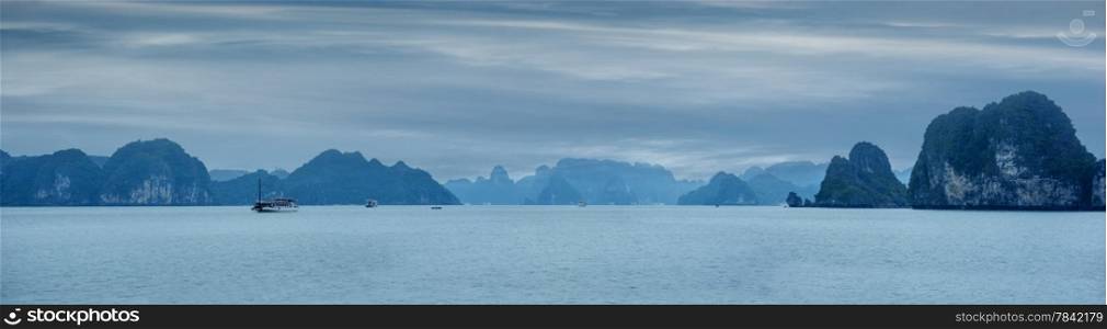 Early morning landscape with blue fog and tourist junks floating among limestone rocks at Ha Long Bay, South China Sea, Vietnam, Southeast Asia. Travel background, four images panorama