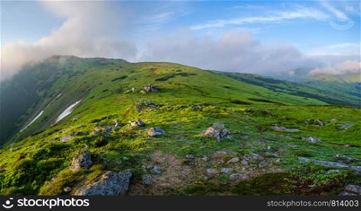 Early morning misty summer mountain panorama with clouds and fog. Carpathian, Ukraine.