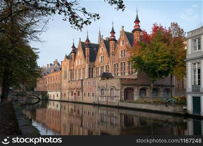 Early morning mood an the channels of Bruges with old buildings reflecting in the water, Belgium