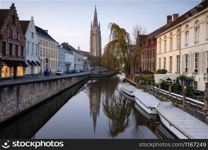 Early morning mood an the channels of Bruges with old buildings reflecting in the water, Belgium