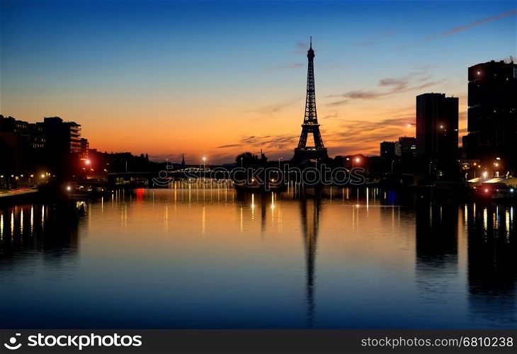 Early morning over Eiffel Tower and skyscrapers in Paris, France