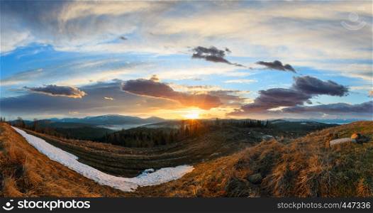 Early morning spring Carpathian mountains plateau landscape with snow-covered ridge tops in far, Ukraine.