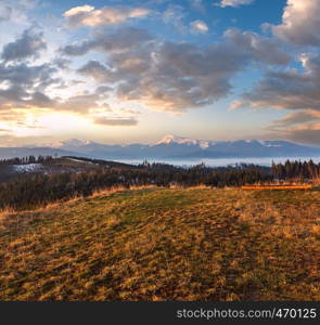 Early morning spring Carpathian mountains plateau landscape with snow-covered ridge tops in far, Ukraine.