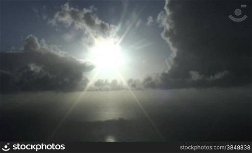 Early morning sun over the sea. Drifitng clouds. Time lapse.