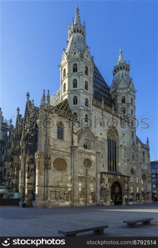 Early morning sunshine on St. Stephen's Cathedral (Stephansdom) in Vienna, Austria. It is the mother church of the Roman Catholic Archdiocese of Vienna and the seat of the Archbishop of Vienna, Christoph Cardinal Schonborn. The current Romanesque and Gothic cathedral, situated in Stephansplatz, stands on the ruins of two earlier churches, the first of which was consecrated in 1147. The current building dates from around 1160.