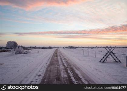 Early winter morning just before sunrise by a country road at a great plain area. From the swedish island Oland.
