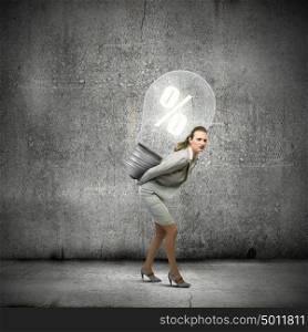 Earning money. Image of businesswoman holding bulb on back