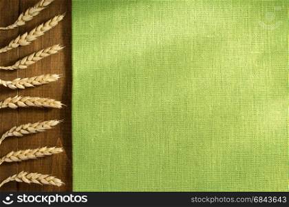 ears of wheat on wood. ears of wheat on wooden background