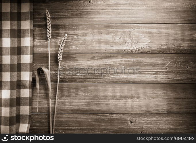 ears of wheat on wooden background