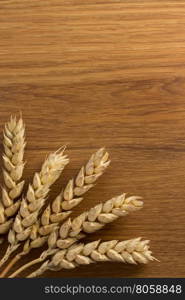 ears of wheat on wooden background