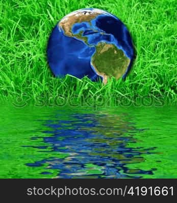 Earth at the succulent green grass background