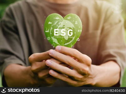 earth day concept Green Energy ESG is in the palm of your hand with a heart-shaped leaf for environment, society and governance. Renewable and sustainable resources Caring for the environment and ecology.