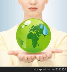 earth day, people, ecology and environment concept - close up of woman holding green globe in her hands